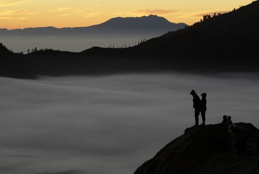 Villagers stand on a crater of Mount Bromo as they wait for sunrise. Bromo crater is among 16 new tourist destiations as part of ecological tourism to attract more foreign tourists to Indonesia. 