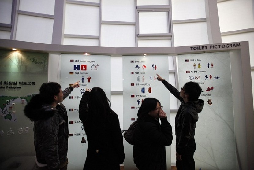 Visitors point to a board with a pictogram of the world's toilets, at the Toilet museum in the Toilet Culture Park in Suwon, South Korea. The park, which is the only one of its type in the world, exhibits a variety of bowls from Korean traditional squat to