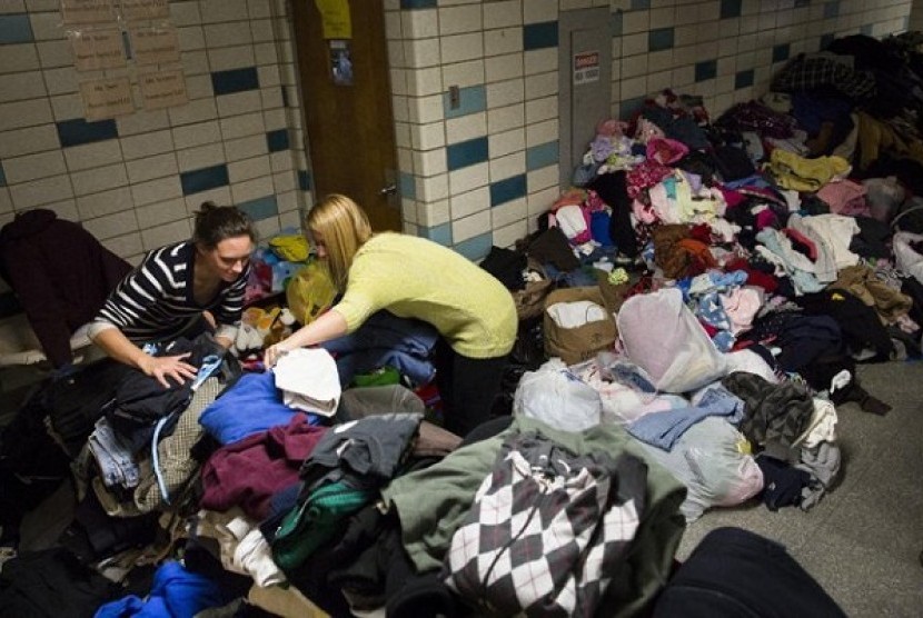 Volunteers at Hoboken High School sort through clothing donations intended for distribution to the public, in Hoboken, N.J. Donations are rolling into New York and New Jersey after Superstorm Sandy, but some relief experts say the things being given are no