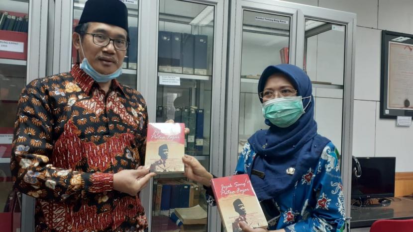   Wakil Kepala BPIP Prof Hariyono (kiri) menerima buku berjudul Jejak Putra Sang Fajar dari Kepala UPT Perpustakaan Bung Karno Janti Suksmarini di Perpustakaan Bung Karno, Blitar, Jawa Timur, Jumat (6/11).