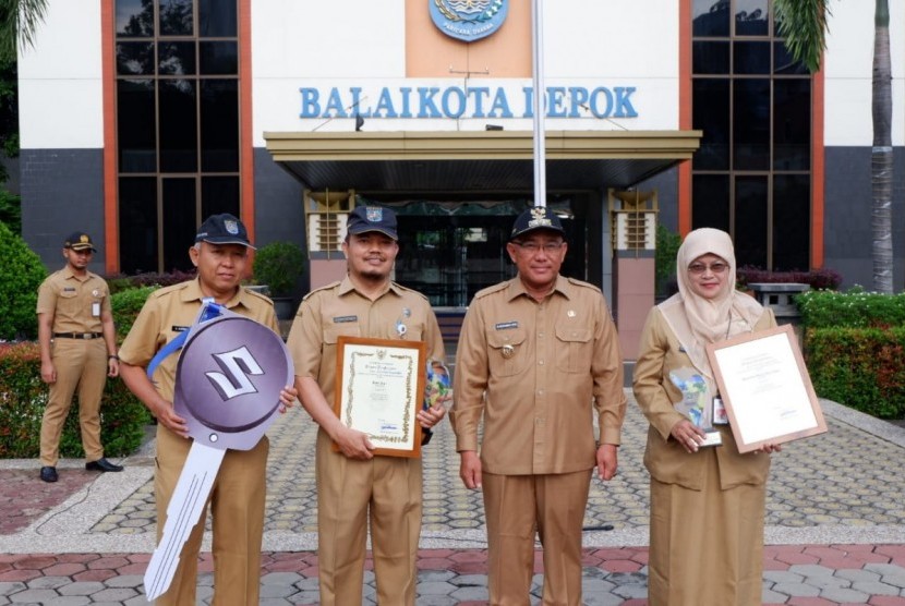 Wali Kota Depok Mohammad Idris menyerahkan Piagam Penghargaan kepada Kepala Dinas Perdagangan dan Perindustrian (Disdagin) Kota Depok Kania Parwanti dan kepala UPTD Pasar Tugu Ikhwan Nasution atas prestasinya.