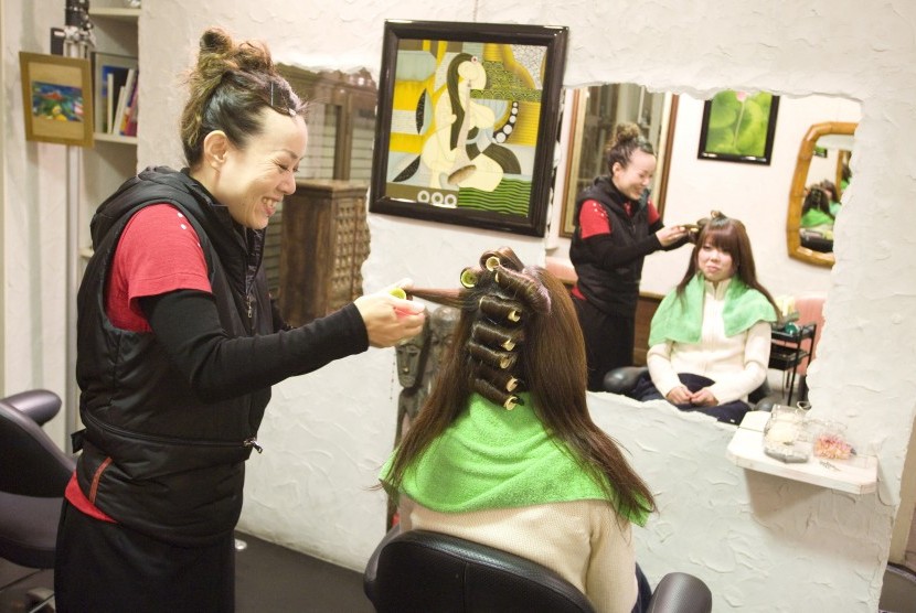 Wanita melakukan penataan rambut salon. Ragam penataan membuat rambut harus terawat dengan tepat.