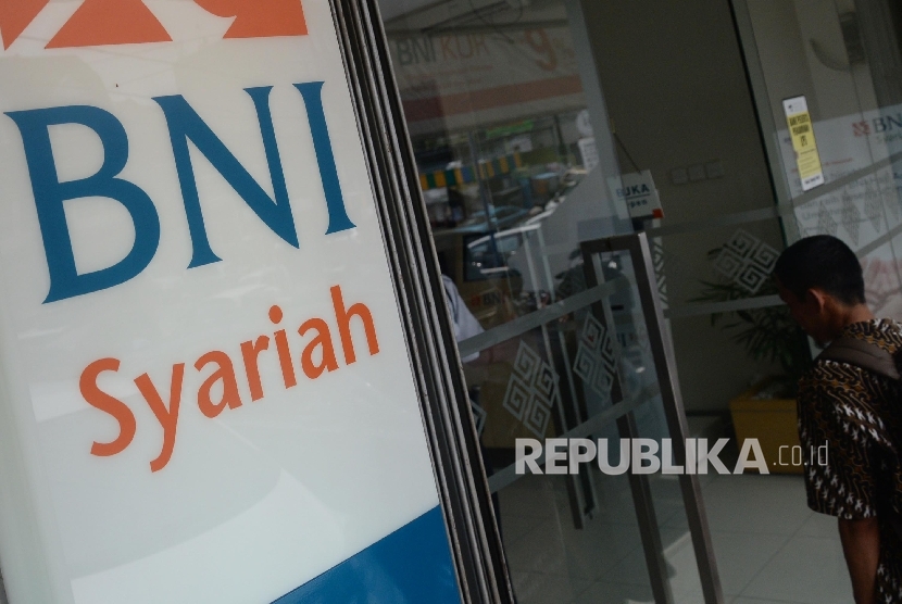 Warga akan melakukan transaksi keuangan di mesin Anjungan Tunai Mandiri (ATM) BNI Syariah, Jakarta, Ahad (8/10).