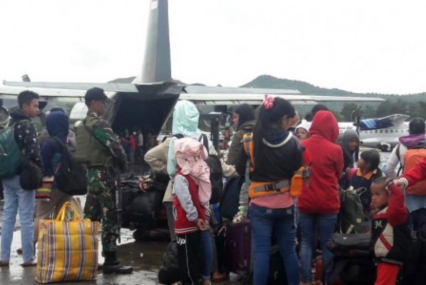Warga antre menaiki pesawat milik TNI di Bandara Wamena, Jayawijaya, Papua, Sabtu (28/9/2019). 