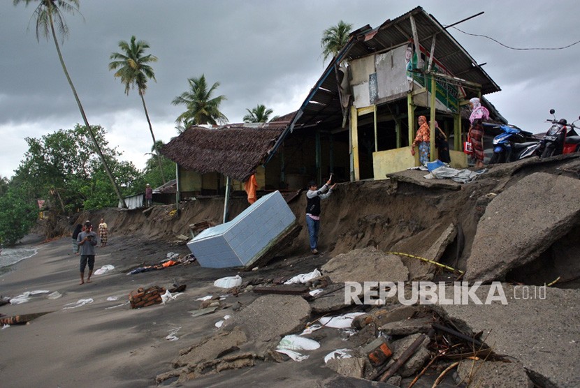 Warga berada di rumahnya yang nyaris roboh akibat abrasi, di Pantai Ulakan, Padangpariaman, Sumatera Barat, Kamis (30/11). 