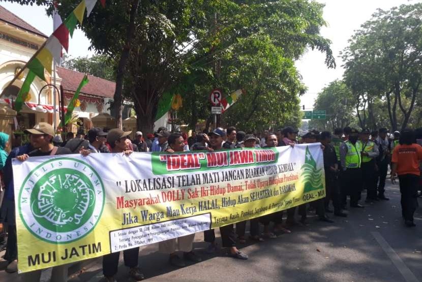 Warga eks lokalisasi Dolly yang menamakan diri Forum Komunikasi Warga Jarak-Dolly (Forkaji) dan Gerakan Umat Islam Bersatu Jawa Timur (GUIB Jatim) kembali menggelar aksi di Kantor Pengadilan Negeri (PN) Surabaya, Senin (3/8). Aksi tersebut merupakan reaksi atas gugatan class action yang dilayangkan Komunitas Pemuda Independen (KOPI) dan Front Pekerja Lokalisasi (FPL) ke PN Surabaya, atas penutupan lokalisasi Dolly.