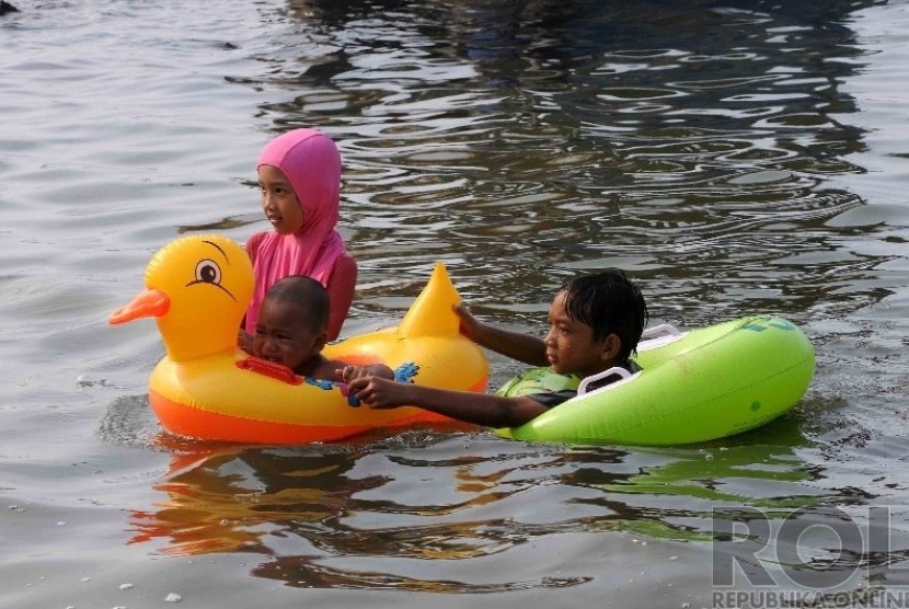 Warga Jakarta dan sekitarnya mengisi liburan dengan berenang di Pantai Festival Taman Impian Jaya Ancol (TIJA), Jakarta, Kamis (25/12). (Republika/Agung Supriyanto)