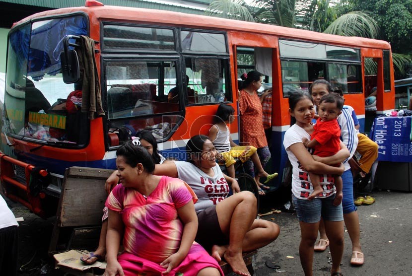   Warga korban banjir mengungsi di bus Metromini di Manggarai, Jakarta Selatan, Senin (13/1). (Republika/Yasin Habibi)