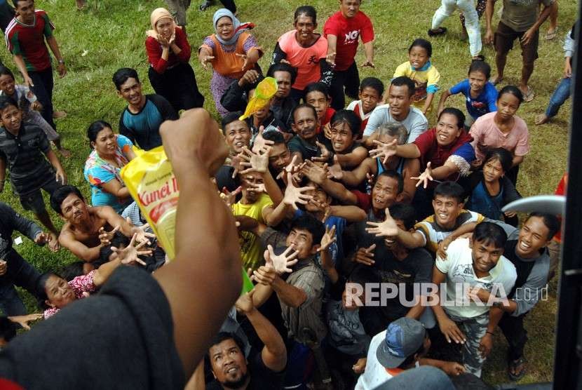 Earthquake victims in Sirenja, Palu, Central Sulawesi, receive assistance dropped from a helicopter, Sunday (October 7).