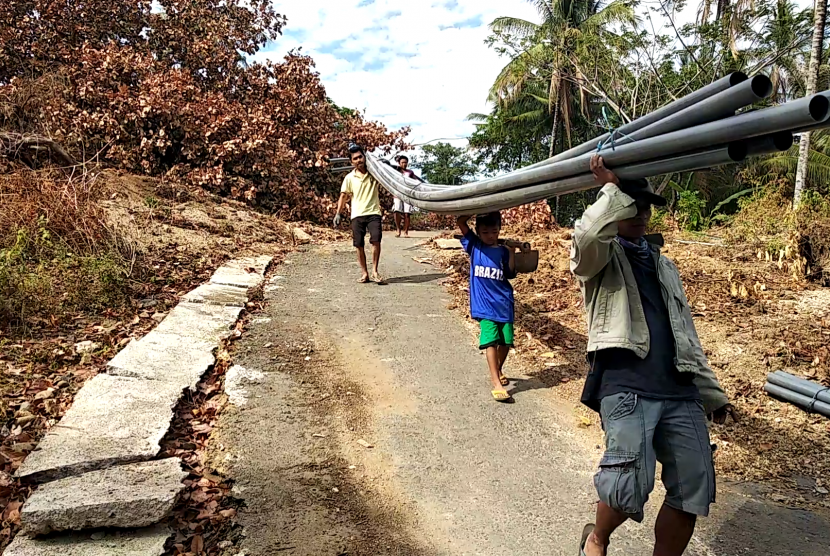 Warga  korban gempa Lombok bergotong royong bersama LAZ Al Azhar membangun pipanisasi.
