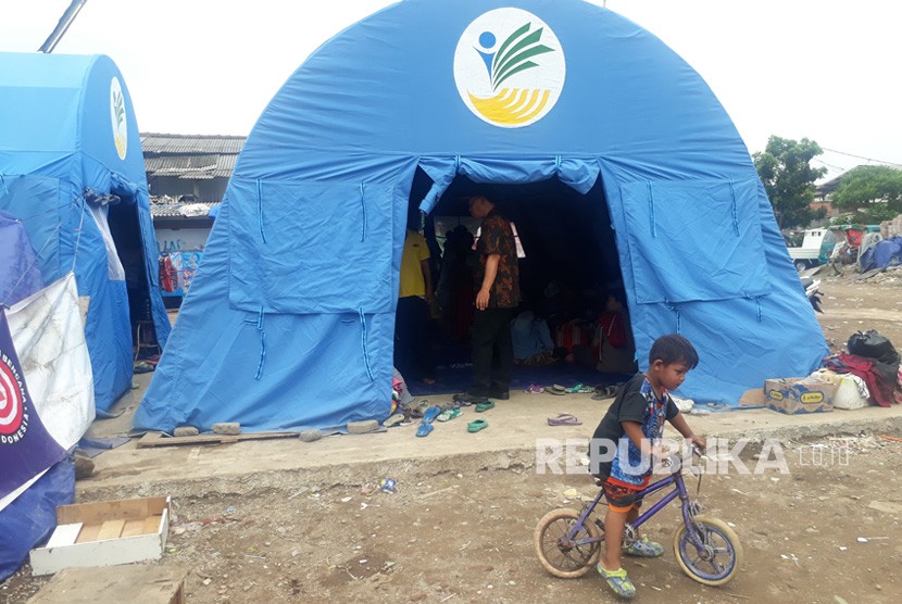 Warga korban kebakaran di Jalan Pasir Koja, Kelurahan Sukahaji masih  bertahan di tenda pengungsian menunggu bantuan rumah tinggal dari  pemerintah. Selama lima hari pasca kebakaran, mereka tinggal di tenda dan  mendapat bantuan makanan.