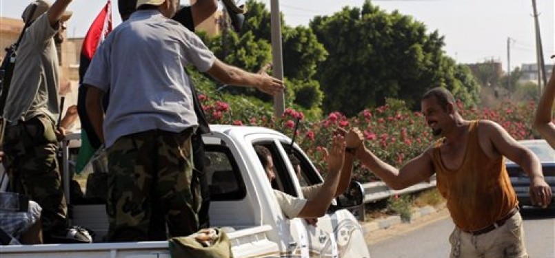  Warga lokal menyambut kedatanganh pasukan pemberontak di pinggiran Tripoli.