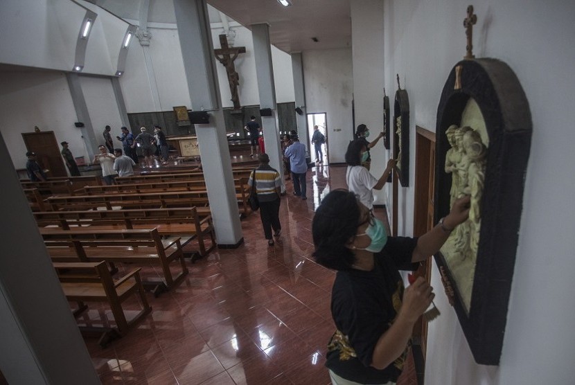 Residents clean up St Lidwina church following an attack by a man who trespassed while carrying a sword during Sunday (Feb 11) morning mass, in Bedog, Sleman, Yogyakarta on Monday (Feb 12). 