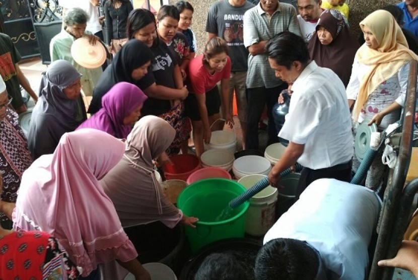Warga Medan mengantre air bersih dari truk tangki PDAM, Selasa (24/10). Pasokan air terhenti sejak Sabtu (21/10) karena kebocoran pada pipa induk
