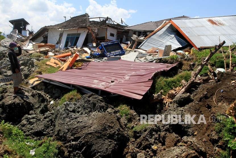 Warga melintas di area lokasi terkena gempa di Petabo, Palu Selatan, Sulawesi Tengah, Senin (1/10).