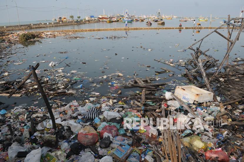 Warga memancing ikan di pantai yang penuh dengan sampah rumah tangga di Desa Branta Pesisir, Pamekasan, Jawa Timur, Selasa (8/6/2021). Tanggal 8 Juni merupakan peringatan Hari Laut Sedunia atau 