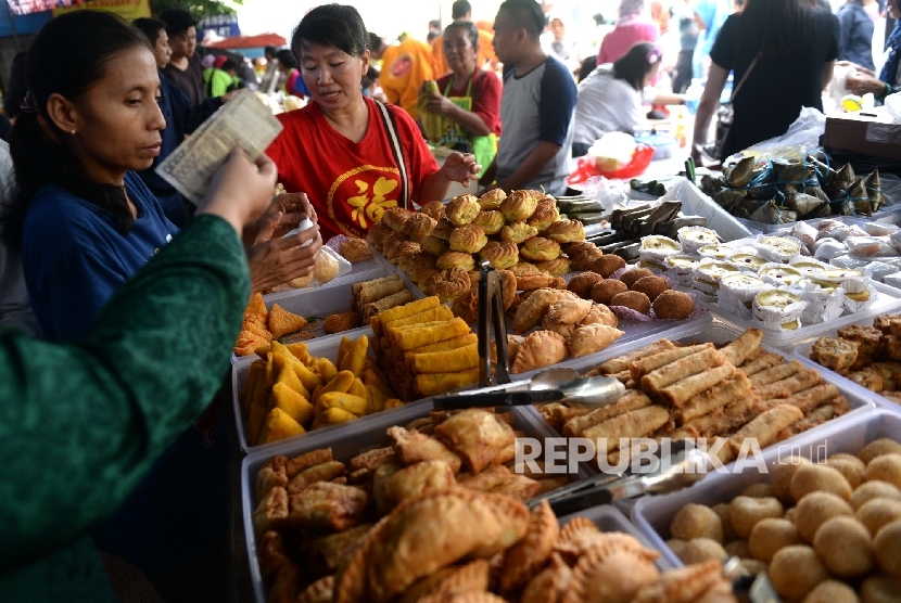 People buy snacks at food stall -- In general every Lebaran consumption would slow down as people had spent a lot during fasting month and for Lebaran, Coordinating minister for economic affairs Darmin Nasution says.
