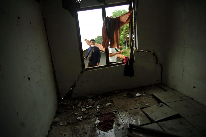 Warga mengamati ruangan kamar yang hancur akibat bencana tanah bergerak (ilustrasi)