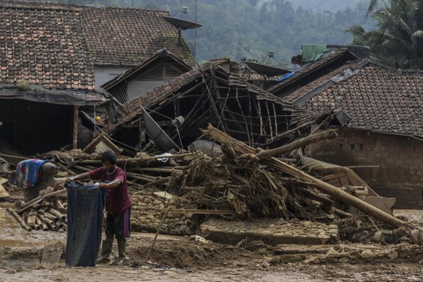 Warga menyelamatkan barang berharga pasca banjir bandang di Desa Purasari, Leuwiliang, Kabupaten Bogor, Jawa Barat.