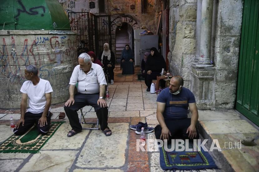 Warga Palestina beribadah di malam yang diyakini sebagai Lailatul Qadar di luar kompleks Masjidil Aqsa yang ditutup karena pandemi Covid-19 selama bulan suci Ramadan di Yerusalem Timur yang dijajah Israel pada 19 Mei 2020.