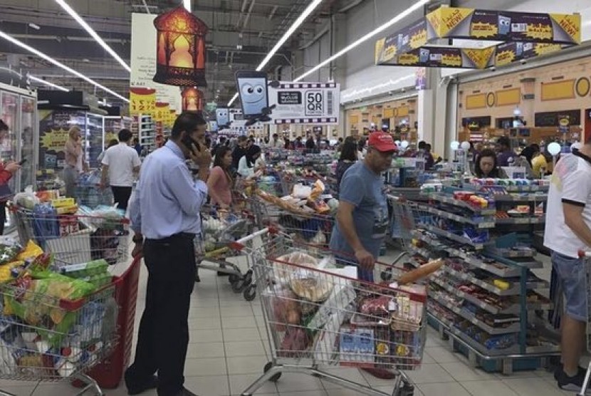 Qatari citizen panic buying food stock in a supermarket at Doha. 
