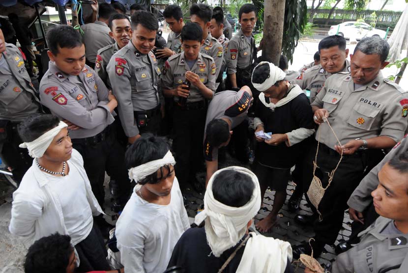 Warga suku asli Baduy menjajakan dagangan khas daerahnya kepada para polisi yang sedang bertugas di kawasan Bundaran Hotel Indonesia (HI), Jakarta, Selasa (6/5).