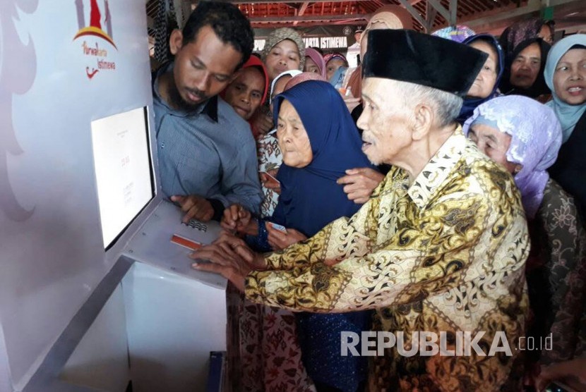 Warga tidak mampu asal Desa Wanakerta, Kecamatan Bungursari, Kabupaten Purwakarta, sedang mencoba ATM beras perelek, Kamis (1/6). Bertepatan dengan momen peringatan Hari Lahir Pancasila, Pemkab Purwakarta meluncurkan fasilitas ATM beras untuk membantu warga. 