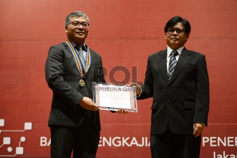  Warsito Purwo Taruno (kiri) menerima penghargaan B.J Habibie Teknologi Award 2015 dari Kepala BPPT Unggul Priyanto (kanan) di Gedung Badan Pengkajian dan Penerapan Teknologi (BPPT), Jakarta, Kamis (20/8). (Republika/Raisan Al Farisi)