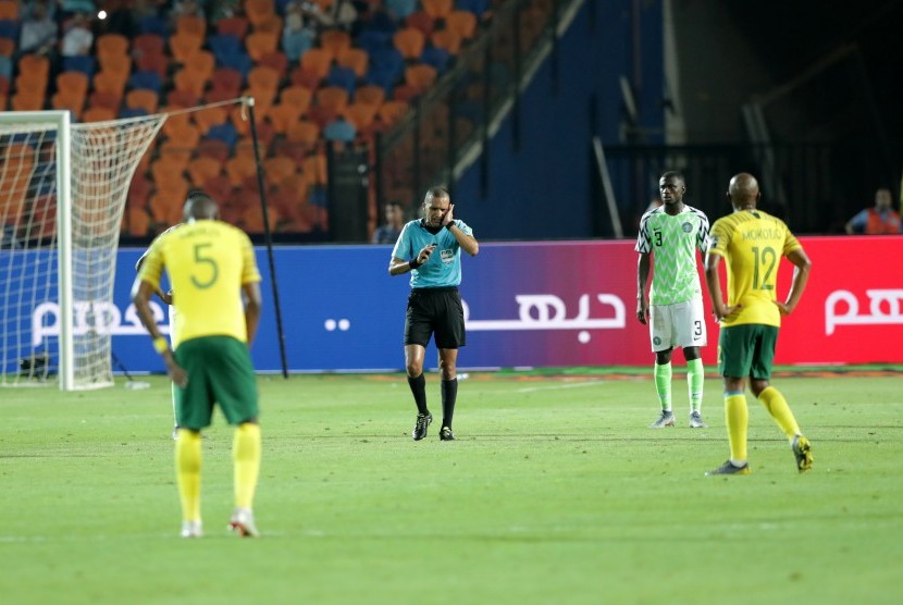 Wasit Jiyed Redouane mensahkan gol timnas Afrika Selatan setelah mendapat review hasil VAR dalam laga perempat final Piala Afrika 2019 antara Nigeria lawan Afrika Selatan di Kairo, Mesir, Rabu (10/7).