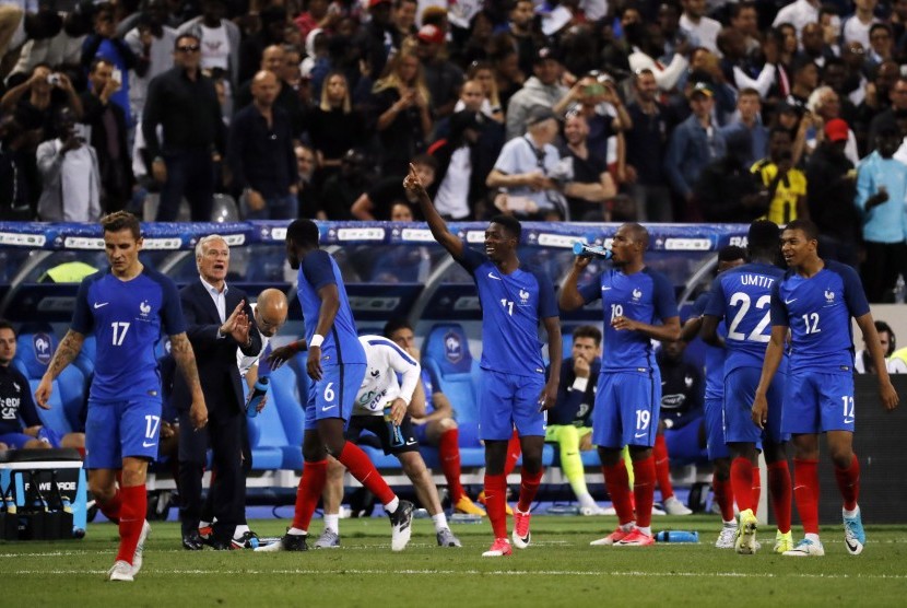 Winger timnas Prancis, Ousmane Dembele (tengah) merayakan gol ke gawang Inggris pada laga persahabatan di Stade de France, Rabu (14/6) dini hari WIB. Prancis menang 3-2.