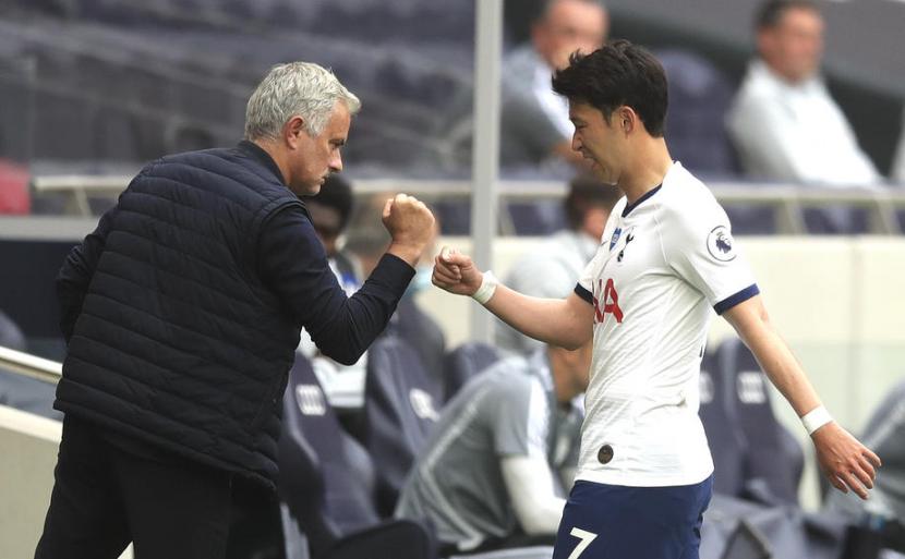 Winger Tottenham Hotspur Son Heung-min (kanan) ditarik keluar lapangan oleh pelatih Jose Mourinho.