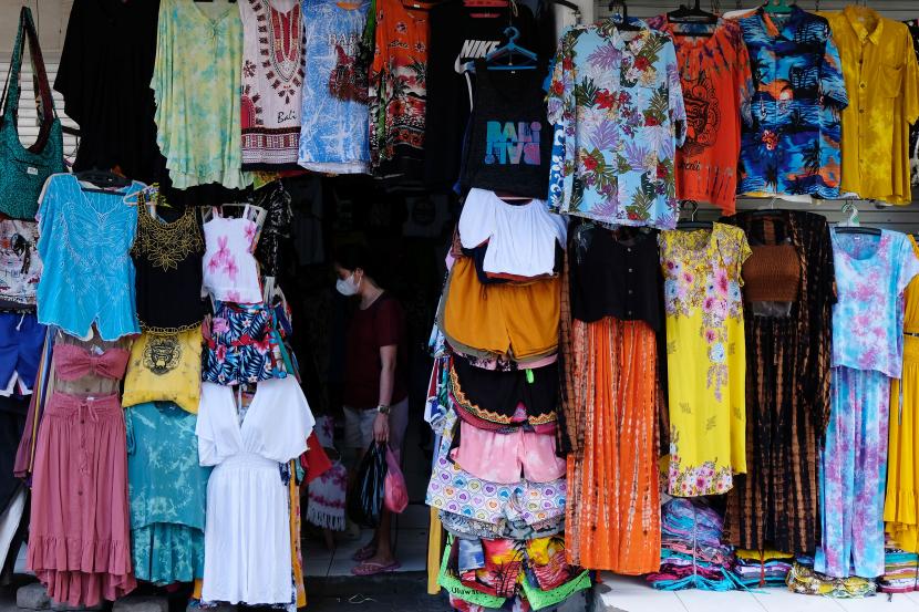 Wisatawan domestik berbelanja pakaian di Pasar Seni Kuta, Badung, Bali, Jumat (15/10/2021). Aktivitas pasar seni tersebut masih sepi pengunjung meskipun pariwisata Bali untuk wisatawan mancanegara sudah dibuka pada Kamis (14/10/2021).
