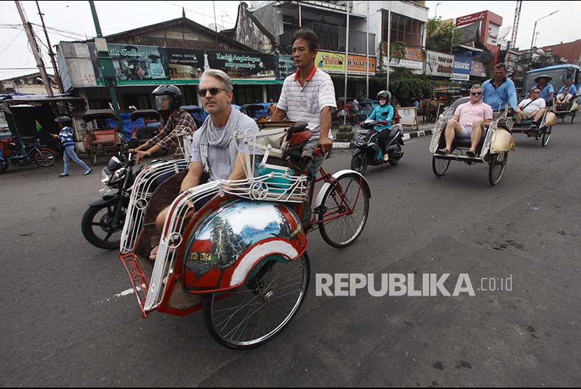 Wisatawan Mancanegara (Wisman) melintasi kawasan Malioboro menggunakan becak di Jl. Malioboro, Daerah Istimewa Yogyakarta, Senin (29/5). Selama tahun 2017, Indonesia memasang target kunjungan wisman sebesar 15 juta. 