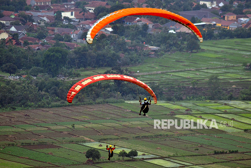 Wisatawan melakukan olahraga Paralayang di kawasan wisata gunung Panten, Kabupaten Majalengka, Jawa Barat, Sabtu (7/4).