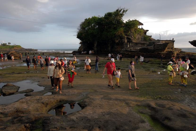 Wisatawan mengunjungi objek wisata Tanah Lot pada pemberlakuan pembatasan kegiatan masyarakat (PPKM) level 3 di Tabanan, Bali, Sabtu (9/10/2021). Objek wisata di Pulau Dewata tersebut mulai ramai dikunjungi wisatawan domestik setelah kasus COVID-19 melandai dan menjelang dibukanya kembali Pariwisata Bali untuk wisatawan mancanegara pada 14 Oktober 2021 mendatang. 