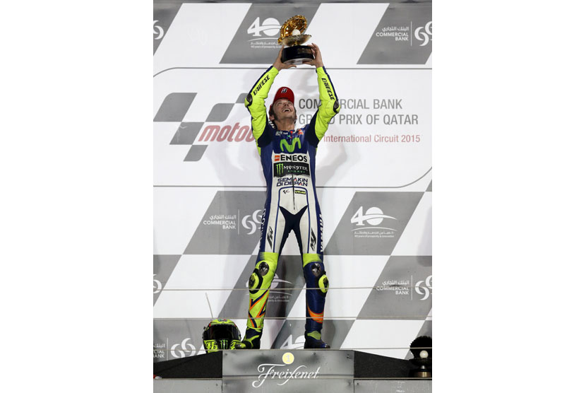 Yamaha MotoGP rider Valentino Rossi of Italy celebrates on the podium after winning the Qatar MotoGP Grand Prix at the Losail International circuit in Doha March 29, 2015