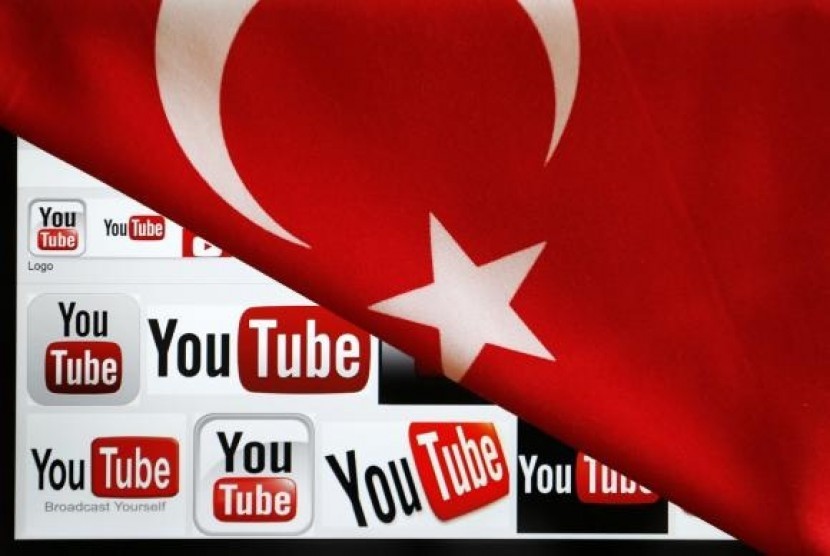 YouTube logos displayed on a laptop screen partially covered with Turkey's national flag in this photo illustration taken in Ankara March 27, 2014.