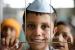 3.500 Pengungsi Afghanistan Tiba di Australia. Seorang anak laki-laki dari Afghanistan tersenyum ketika dia difoto, sambil menunggu dengan pengungsi lain untuk terbang ke Amerika Serikat atau lokasi penyelamatan lainnya di gerbang keberangkatan darurat di dalam gantungan di Pangkalan Udara Amerika Serikat di Ramstein, Jerman, Rabu, 1 September , 2021.
