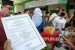 Pengunjung menyaksikan sejumlah produk Usaha Kecil dan Menengah (UKM) yang dipamerkan pada kegiatan penyerahan sertifikat halal di Kantor Majelis Permusyawaran Ulama (MPU), Aceh Besar, Aceh, Kamis (12/12/2019).