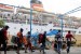 Calon penumpang berjalan menuju tangga kapal milik PT Pelni KM Nggapulu yang merapat di Pelabuhan Ambon, Maluku, Senin (11/6).