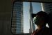 Dalam file foto tanggal 26 April 2020 ini, seorang komuter yang mengenakan masker untuk membantu mengekang penyebaran virus corona, tidur di dalam Metro tanpa pengemudi saat melewati Burj Khalifa, gedung tertinggi di dunia, di Dubai, Uni Emirat Arab. 