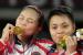 Greysia Polii dari Indonesia, kiri, dan Apriyani Rahayu merayakan dengan medali emas mereka setelah mengalahkan Chen Qing Chen dan Jia Yi Fan dari China dalam pertandingan perebutan medali emas ganda putri di Olimpiade Musim Panas 2020, Senin, 2 Agustus 2021, di Tokyo, Jepang.
