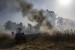  Pemadam kebakaran Israel memadamkan api yang berasal dari alat pembakar yang diluncurkan dari Jalur Gaza, dekat pagar perbatasan Israel dan Gaza, Rabu, (15/5). Rakyat Palestina menandai peringatan Hari Nakba ke-71 dengan berdemonstrasi di Tepi Barat yang diduduki Israel dan Jalur Gaza.