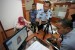 Imigrasi Bojonegoro Pastikan Paspor Haji Jadi dalam 5 Menit. Petugas Imigrasi melayani pembuatan paspor jamaah calon haji Indonesia yang sedang sakit. 