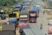Sejumlah kendaraan truk berjalan merayap di ruas Jalan Ir Soekarno Hatta Kota Bandarlampung, Selasa (9/07). Jalan lintas Sumatera itu menjadi salah satu titik rawan macet saat arus mudik karena pengerjaan pelebaran badan jalan yang belum rampung sejak bebe
