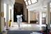 Seorang pekerja mengenakan pakaian pelindung (hazmat) dan masker mengepel lantai di Masjid Hajjah Fatimah di Singapura, Jumat (13/3). Singapura membuka ruang shalat terbatas untuk jamaah pekerja di sejumlah masjid terkait wabah corona.
