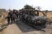 Warga melihat reruntuhan sebuah van yang hancur di dekat desa Barisha, Idlib, Suriah setelah operasi militer AS yang menargetkan pemimpin ISIS Abu Bakr al-Baghdadi, Ahad (27/10). Pertempuran ISIS-Kurdi Berlanjut, 120 Orang Tewas Selama Empat Hari