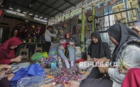 Sejumlah perajin menyelesaikan kerajinan bunga berbahan sampah plastik di Bank Sampah Persatuan, Duren Sawit, Jakarta, Jumat (23/2/2024). Selain untuk meningkatkan nilai jual limbah plastik, pemberdayaan masyarakat dalam produksi kerajinan daur ulang tersebut juga bertujuan mengampanyekan cara memproses yang lebih bijak dan ramah lingkungan. 