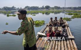 Sejumlah siswa SDN Budiharja menyeberangi perairan Waduk Saguling menggunakan rakit di Cililin, Kabupaten Bandung Barat, Jawa Barat, Jumat (28/8/2026). Sejumlah siswa dan warga dari Kampung Sadang serta Kampung Gombong sejak tahun 1990 terpaksa menyeberangi perairan Waduk Saguling menggunakan rakit atau perahu untuk sekolah serta beraktivitas sehari-hari guna memangkas waktu perjalanan menjadi 10 menit dibandingkan dengan jalur darat yang mencapai 30 menit hingga satu jam. 