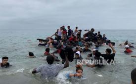 Para migran berhasil mengambil perahu otoritas Maroko di dekat pantai Fnideq (Maroko) dalam upaya untuk menyeberang ke Ceuta, kantong Spanyol di Afrika utara, Selasa (18/5),  ketika pasukan tentara Spanyol dikerahkan setelah total 5.000 orang Maroko warga negara berhasil memasuki kota melalui laut pada malam hari dan ratusan migran terus berdatangan.